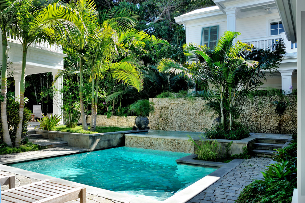 Example of a mid-sized island style home design design in Miami