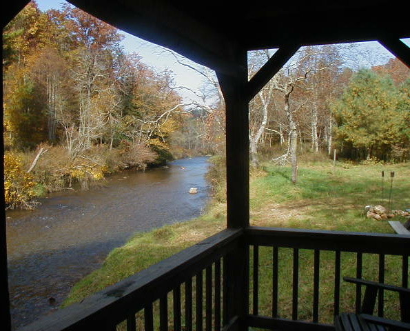 Example of a mid-sized mountain style backyard dock design in Raleigh with a pergola