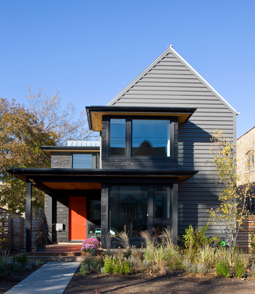 Mid-sized modern two-storey black exterior in Chicago with mixed siding and a gable roof.