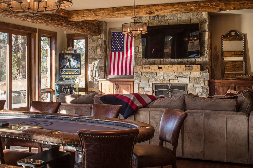 Basement - large rustic walk-out dark wood floor basement idea with beige walls, a standard fireplace and a stone fireplace