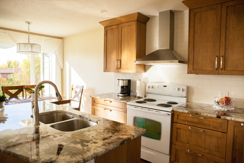 Example of a transitional kitchen design in Calgary