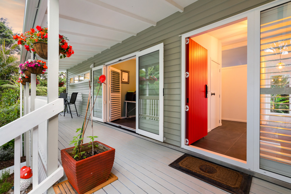 Design ideas for a medium sized modern front door in Auckland with green walls, painted wood flooring, a red front door and grey floors.