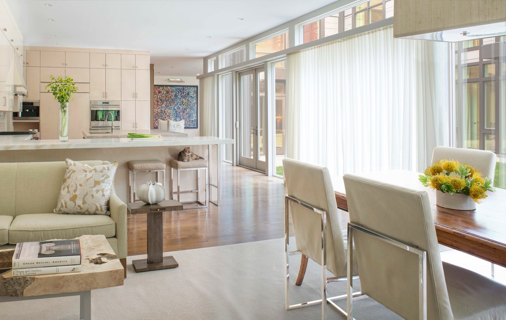 Huge transitional medium tone wood floor eat-in kitchen photo in DC Metro with flat-panel cabinets, light wood cabinets, marble countertops, white backsplash, stainless steel appliances and an island