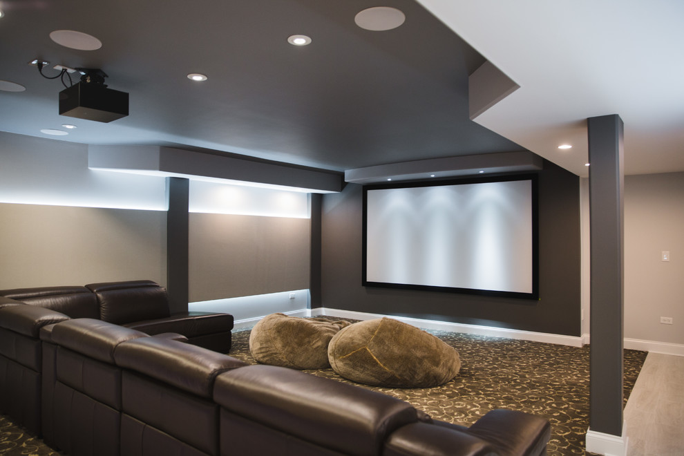 Photo of a contemporary open concept home theatre in Chicago with a projector screen and brown walls.