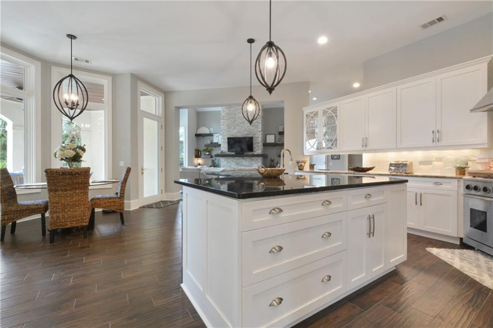 Kitchen - large transitional kitchen idea with shaker cabinets, white cabinets, granite countertops and an island