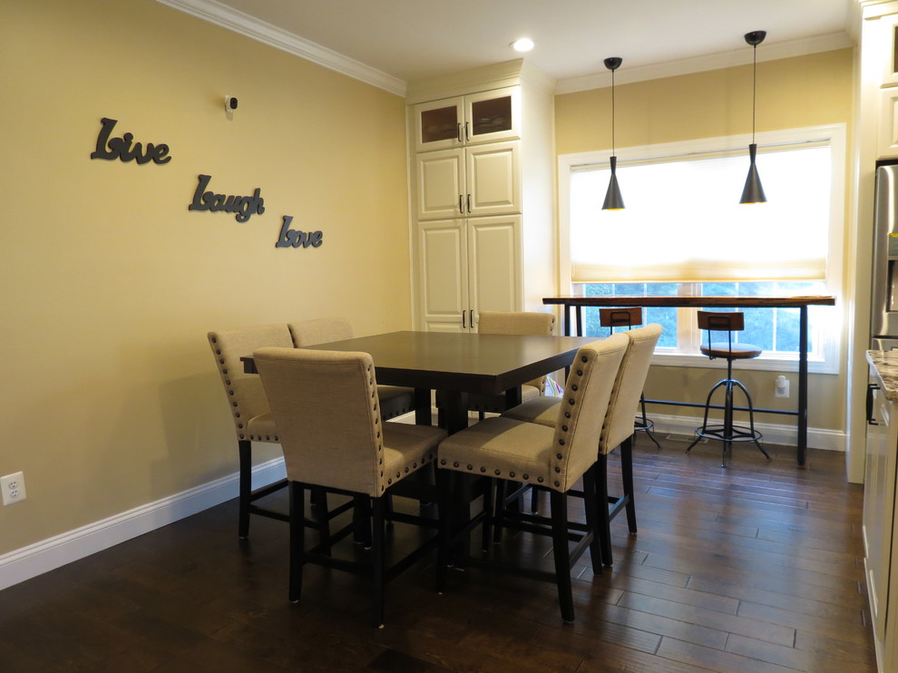 Large transitional galley dark wood floor and brown floor kitchen photo with a double-bowl sink, raised-panel cabinets, white cabinets, granite countertops, white backsplash, porcelain backsplash, stainless steel appliances and an island