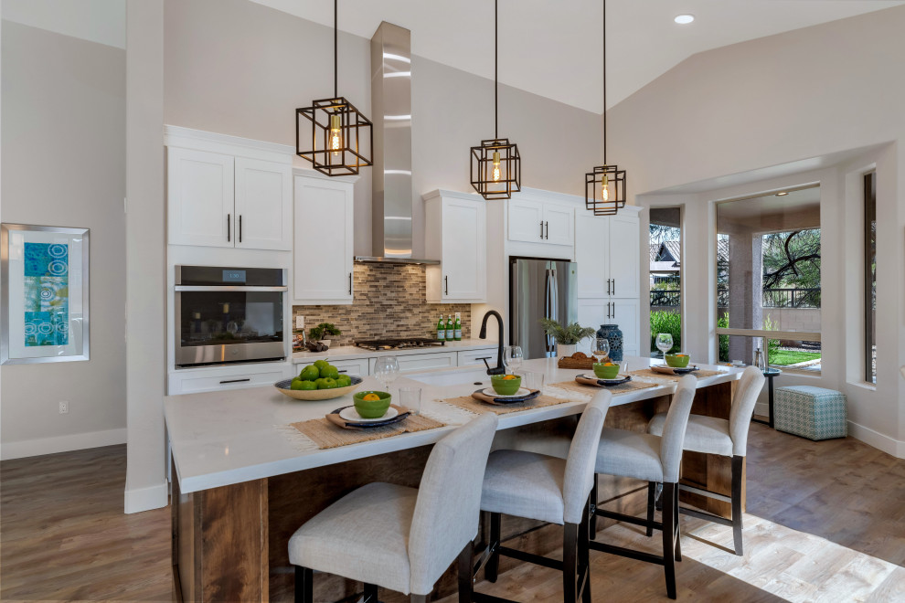 Inspiration for a transitional vinyl floor and brown floor kitchen remodel in Phoenix with shaker cabinets, dark wood cabinets, quartz countertops, an island and white countertops