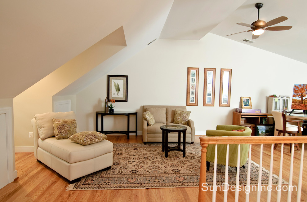 Contemporary loft-style family room in DC Metro with beige walls and light hardwood floors.