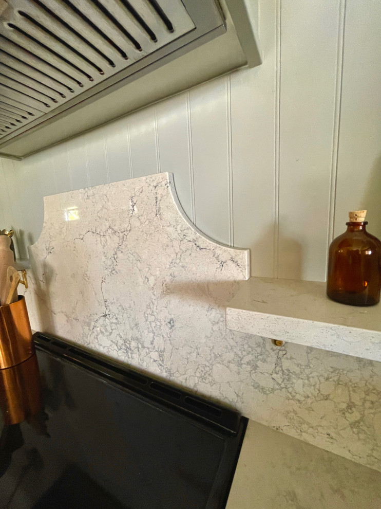 Example of a mid-sized transitional marble floor and multicolored floor kitchen design with green cabinets, quartz countertops, white backsplash, quartz backsplash, stainless steel appliances and white countertops