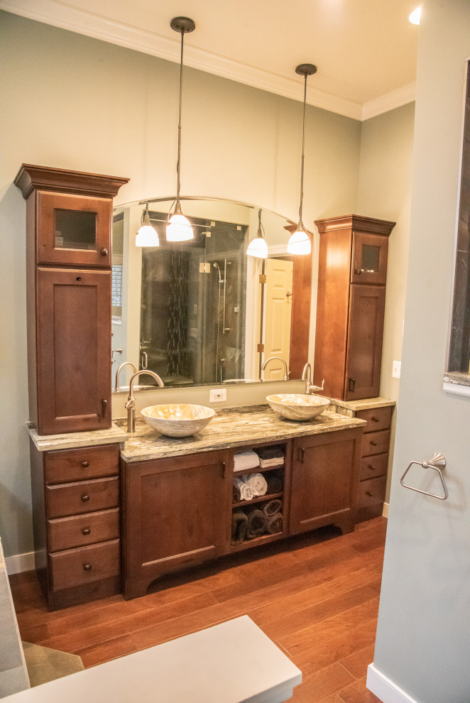 Example of a large mountain style dark wood floor, brown floor and double-sink bathroom design in Baltimore with recessed-panel cabinets, brown cabinets, a vessel sink, granite countertops and a built-in vanity