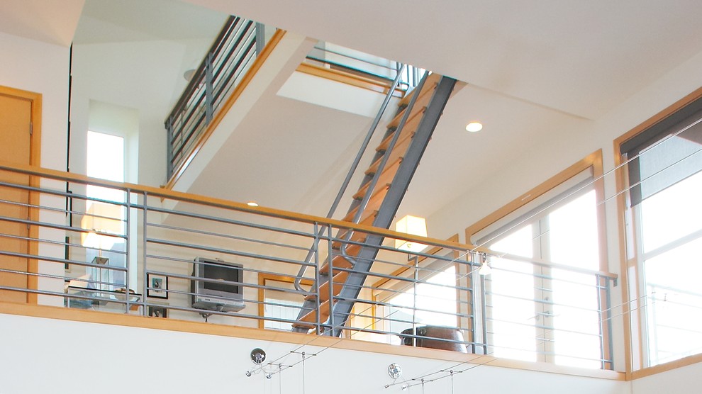 Inspiration for a mid-sized modern wood straight staircase in Seattle with open risers and metal railing.