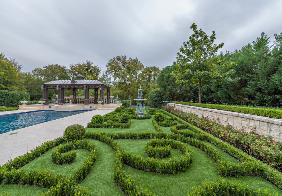 Large traditional backyard formal garden in Dallas.