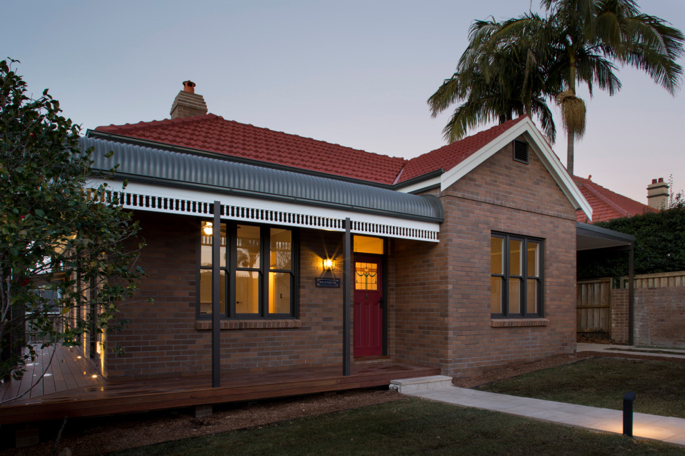 Inspiration for a mid-sized traditional one-storey brick brown house exterior in Sydney with a hip roof and a metal roof.