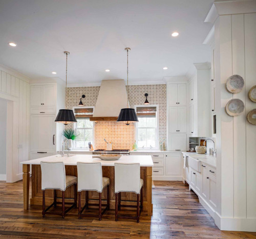 Wolf gas range, white oak kitchen island with seating, custom plaster range hood, full height cabinets, vertical shiplap walls, and reclaimed mixed hardwood flooring.
Example of a cottage u-shaped medium tone wood floor and brown floor kitchen design in Other with a farmhouse sink, shaker cabinets, white cabinets, marble countertops, ceramic backsplash, stainless steel appliances, an island and white countertops 