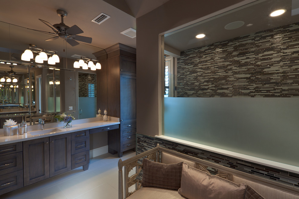 Transitional bathroom in Miami with raised-panel cabinets, brown cabinets, marble benchtops and white tile.