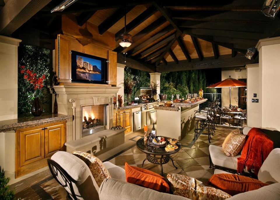 Inspiration for an expansive traditional backyard patio in Other with an outdoor kitchen, tile and a roof extension.