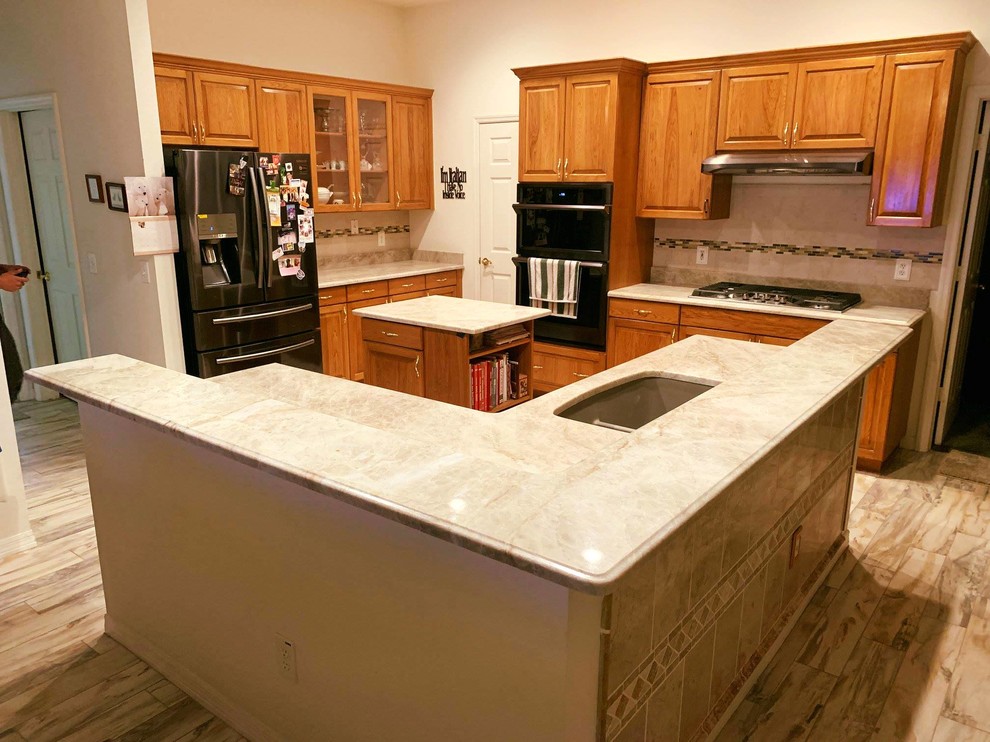Photo of a large modern l-shaped kitchen pantry in Tampa with a single-bowl sink, quartzite benchtops and multiple islands.