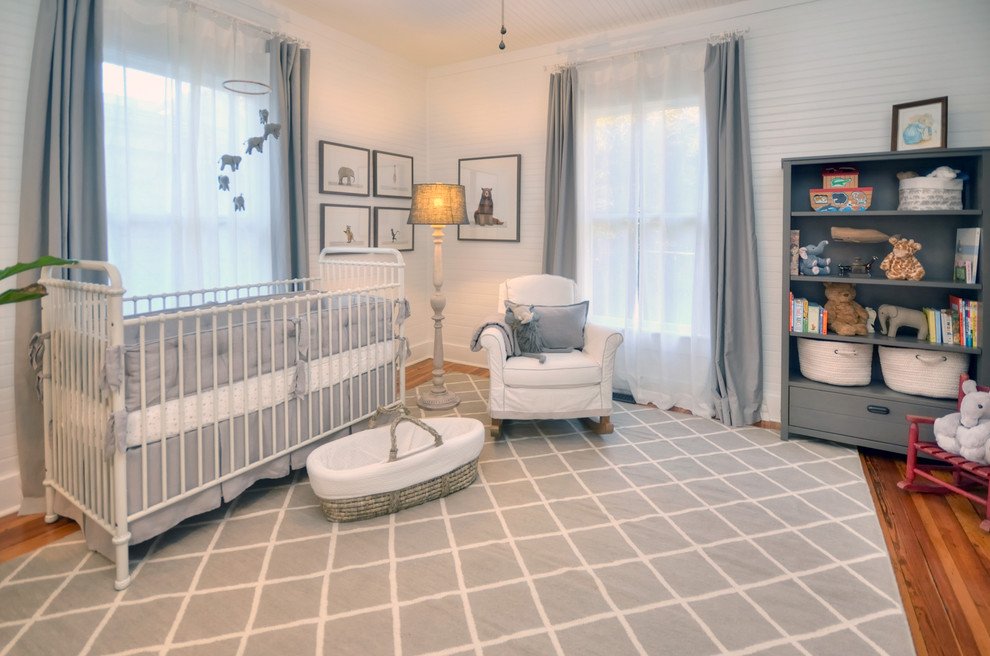Mid-sized country gender-neutral nursery in Other with white walls, medium hardwood floors and grey floor.