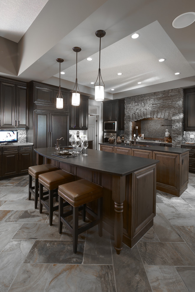 Design ideas for a traditional kitchen in Calgary with raised-panel cabinets, dark wood cabinets, grey splashback and panelled appliances.