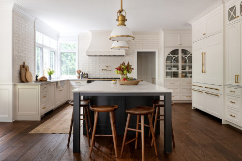 Bright white kitchen with dark island, wood stools and arched glass kitchen cabinet on the back wall