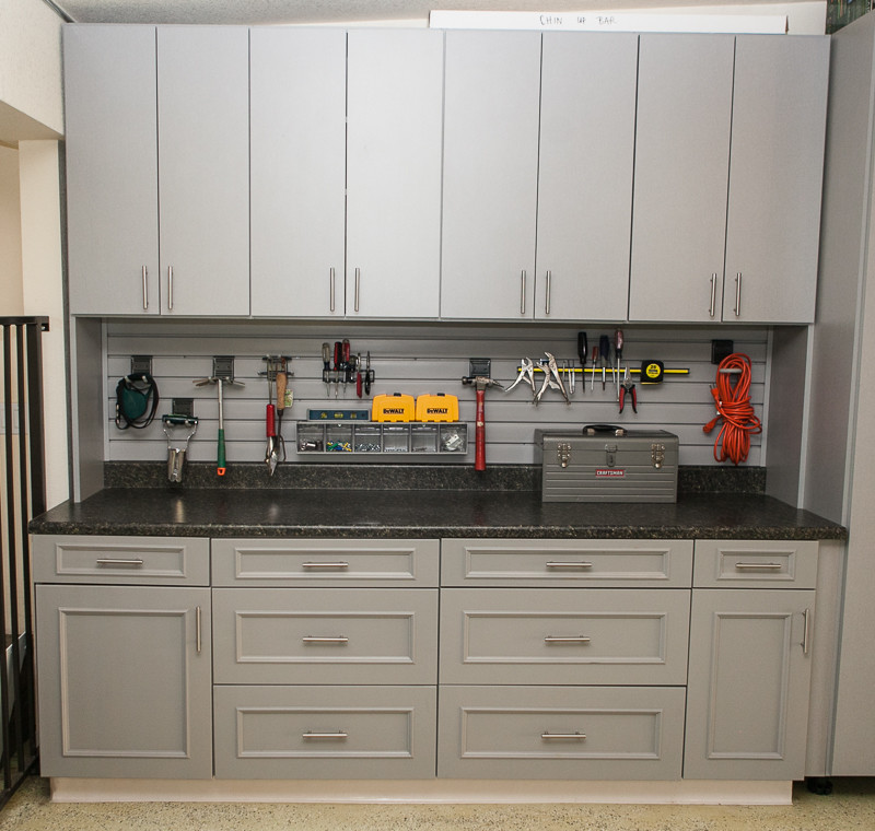 Example of a mid-sized arts and crafts attached garage workshop design in Denver