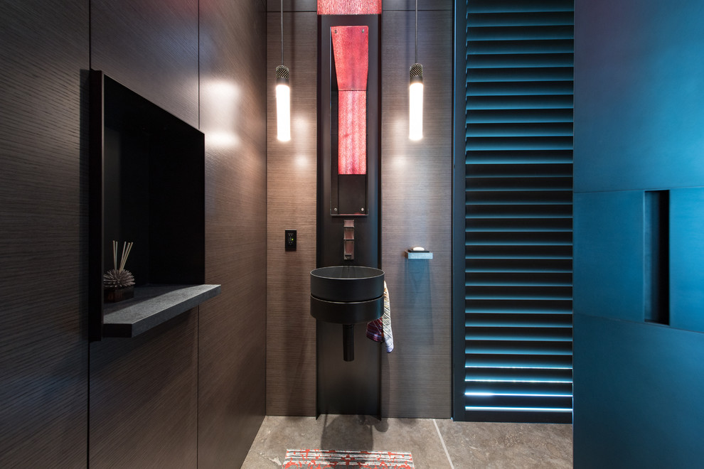 Mid-sized contemporary powder room in Seattle with brown walls, concrete floors, a wall-mount sink and brown floor.