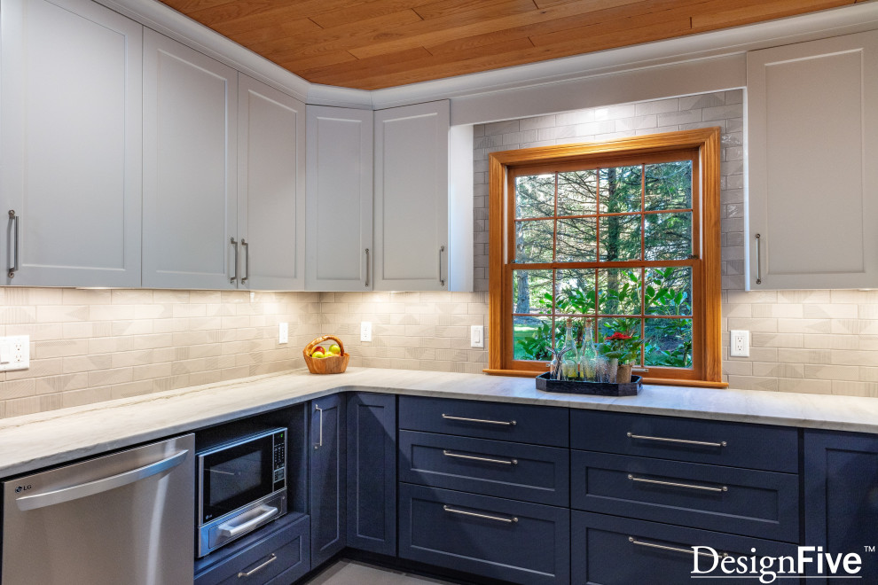 Open concept kitchen - large modern u-shaped gray floor and wood ceiling open concept kitchen idea with an undermount sink, shaker cabinets, blue cabinets, quartz countertops, gray backsplash, ceramic backsplash, stainless steel appliances and no island