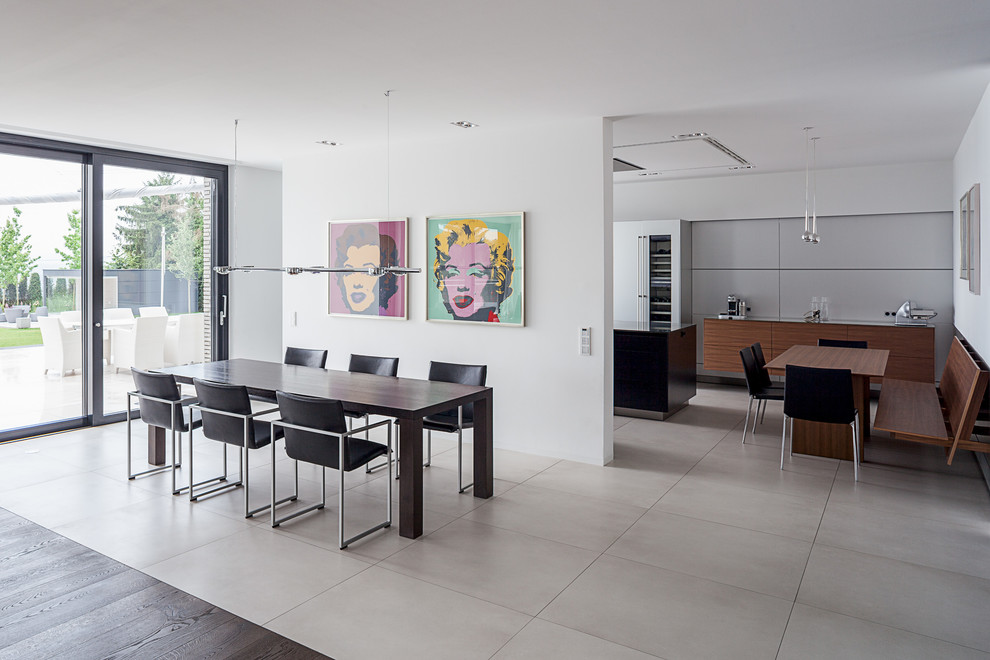 This is an example of a mid-sized contemporary open plan dining in Cologne with white walls.