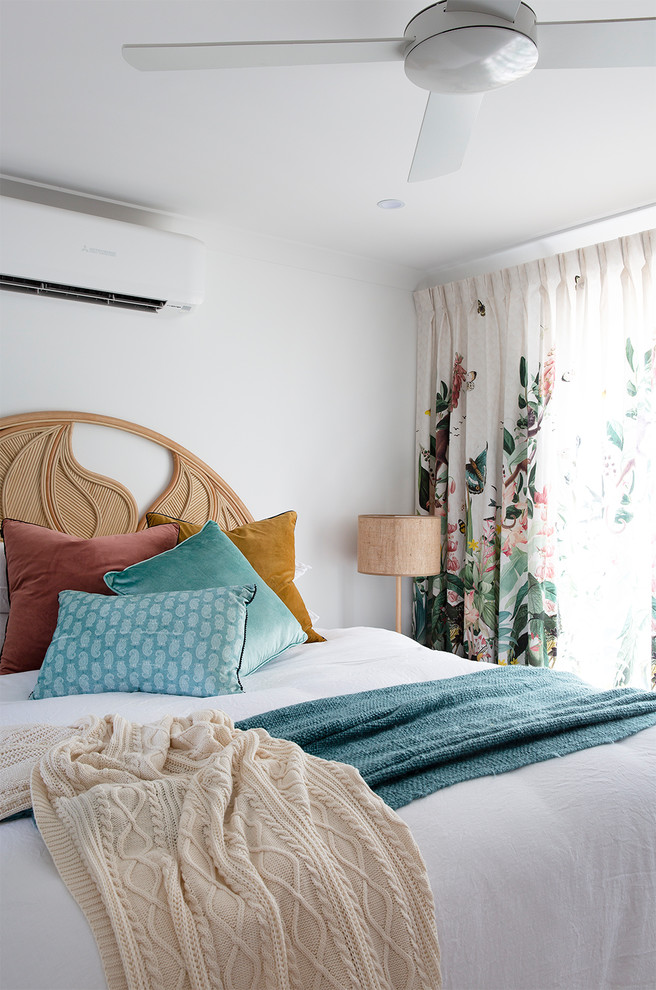 This is an example of a beach style bedroom in Sunshine Coast with white walls.