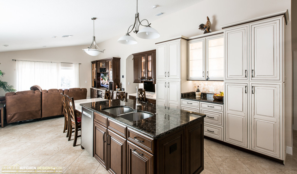 This is an example of a large traditional u-shaped eat-in kitchen in Orlando with an undermount sink, raised-panel cabinets, beige cabinets, quartz benchtops, multi-coloured splashback, stone tile splashback, stainless steel appliances, porcelain floors and with island.