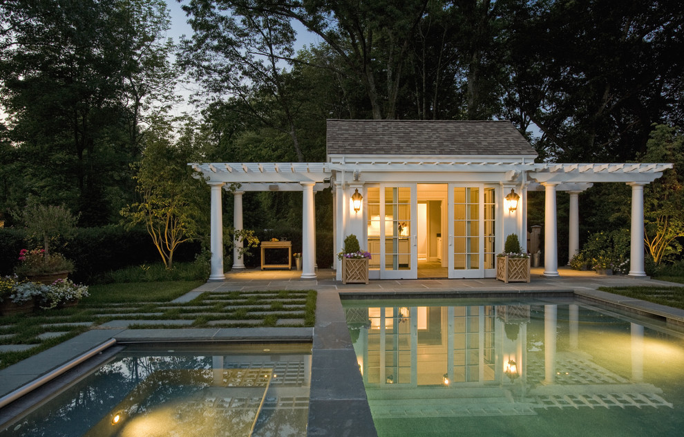 This is an example of a traditional rectangular pool in Boston with a pool house.