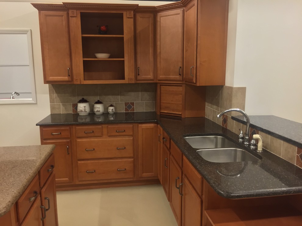 Kitchen pantry - large traditional l-shaped ceramic tile kitchen pantry idea in Miami with a double-bowl sink, recessed-panel cabinets, medium tone wood cabinets, granite countertops, beige backsplash, ceramic backsplash, stainless steel appliances and an island