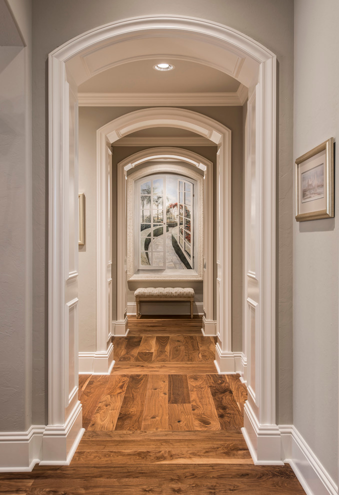 Inspiration for a mid-sized transitional hallway in Miami with grey walls and medium hardwood floors.