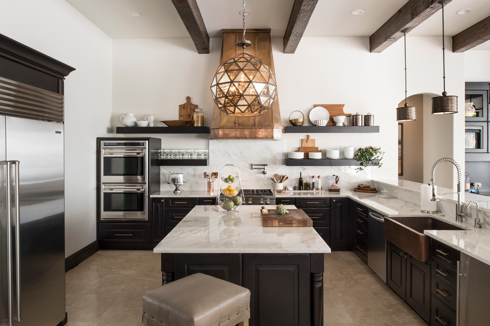 Design ideas for a mediterranean u-shaped kitchen in Orlando with a farmhouse sink, raised-panel cabinets, white splashback, stainless steel appliances and with island.