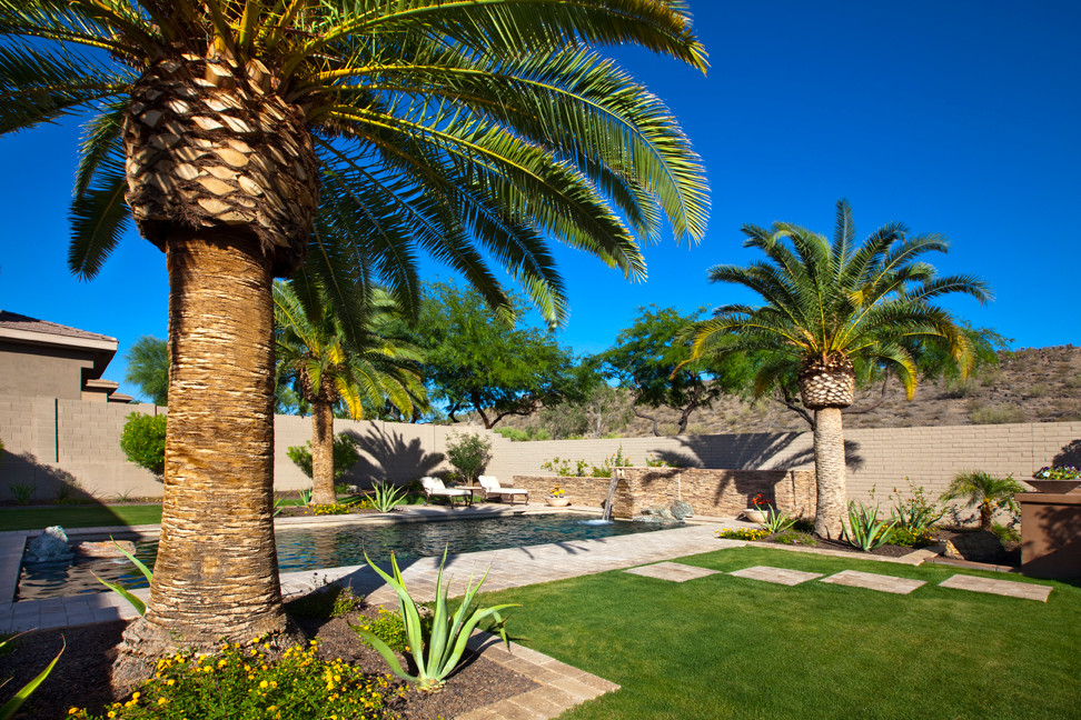 Design ideas for a large transitional backyard brick landscaping in Phoenix.