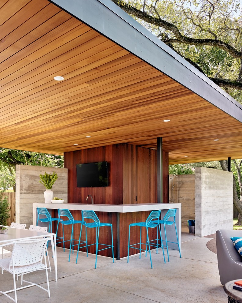 Contemporary l-shaped seated home bar in Austin with flat-panel cabinets and dark wood cabinets.