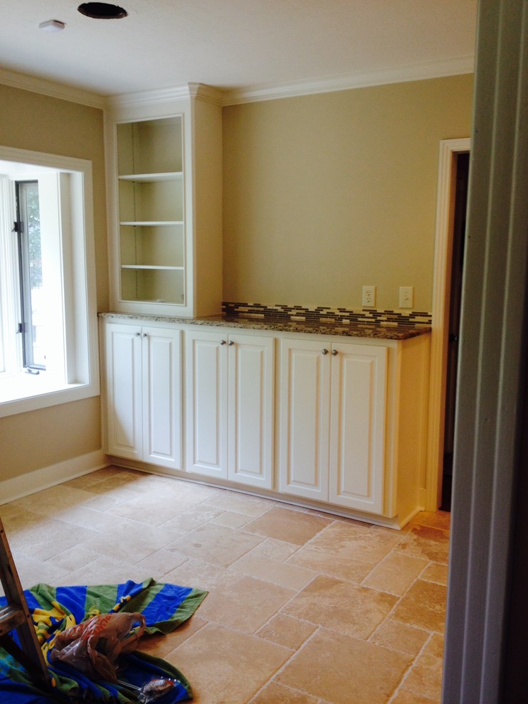 Inspiration for a mid-sized transitional galley ceramic tile enclosed kitchen remodel in Jackson with a double-bowl sink, flat-panel cabinets, white cabinets, granite countertops, brown backsplash, mosaic tile backsplash, stainless steel appliances and no island