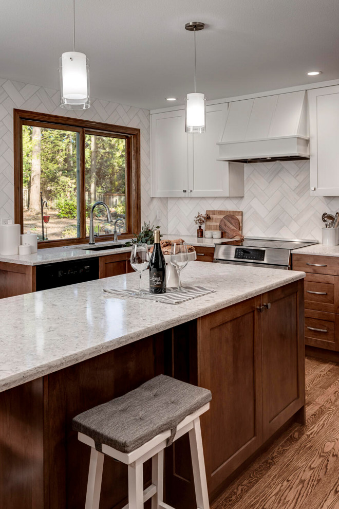 Mid-sized transitional u-shaped kitchen in Seattle with an undermount sink, recessed-panel cabinets, medium wood cabinets, quartz benchtops, red splashback, marble splashback, stainless steel appliances, medium hardwood floors, with island, brown floor and beige benchtop.