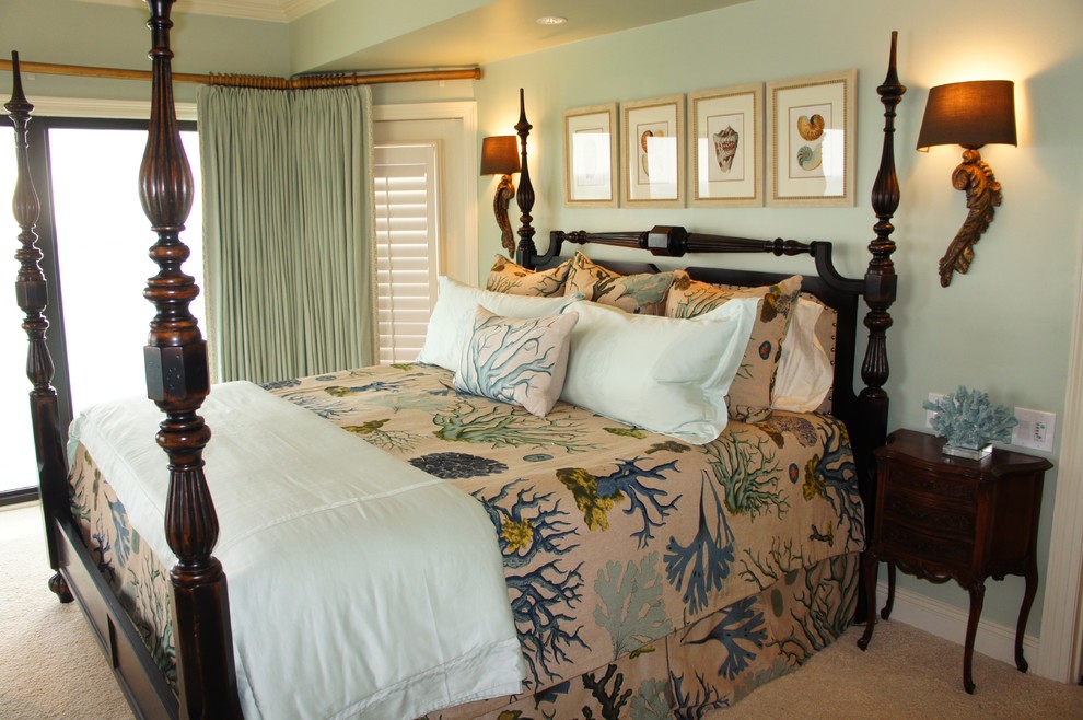 This is an example of a large beach style master bedroom in Miami with blue walls and carpet.