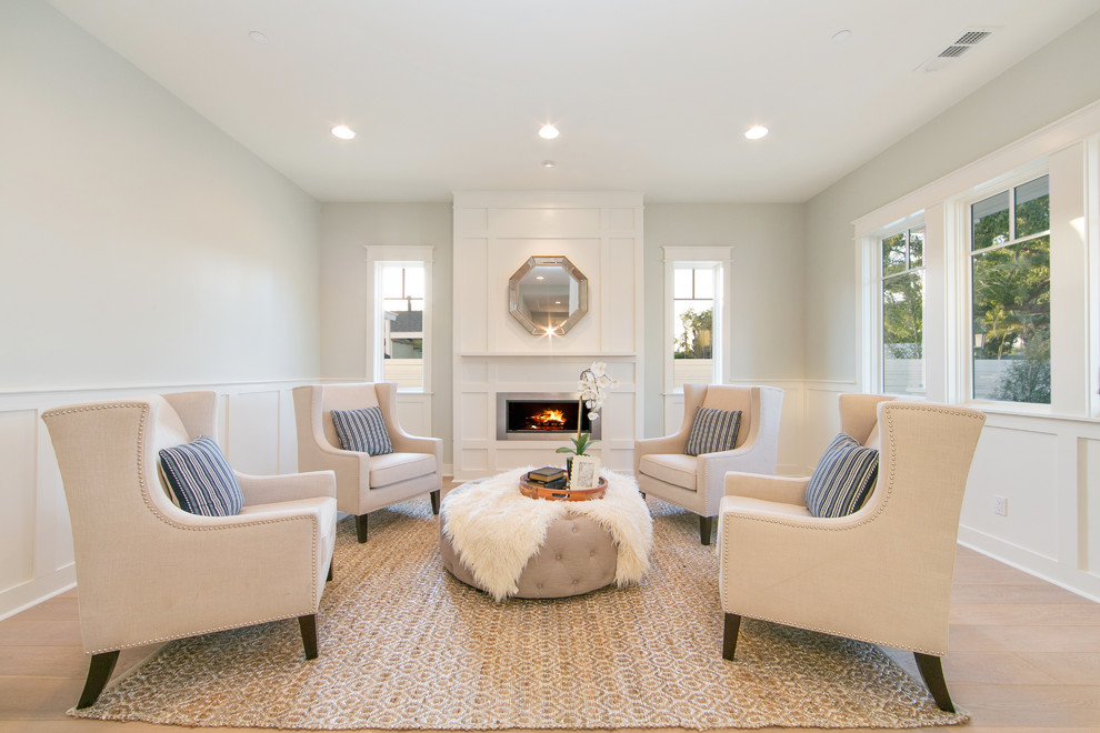 Inspiration for a large traditional formal enclosed living room in Orange County with grey walls, light hardwood floors, a ribbon fireplace, no tv and a metal fireplace surround.