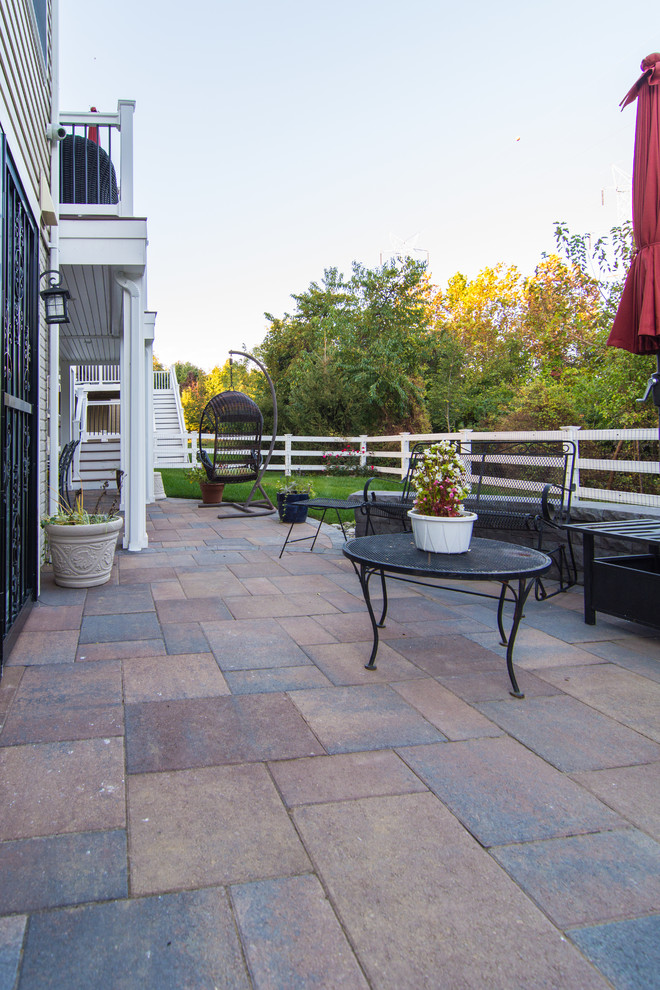 Photo of a large transitional backyard patio in DC Metro with concrete pavers and no cover.