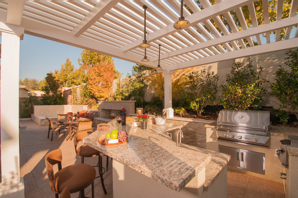 Photo of a large contemporary backyard patio in San Francisco with an outdoor kitchen, a pergola and tile.