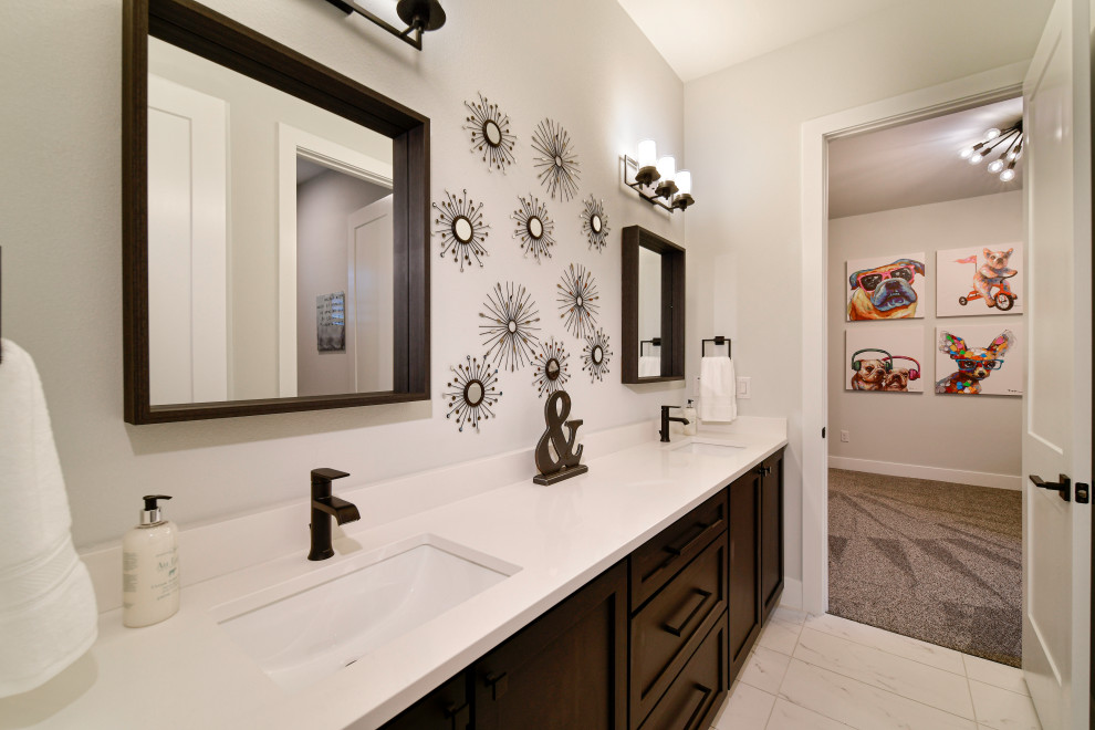 This is an example of a mid-sized transitional kids bathroom in Other with shaker cabinets, black cabinets, a two-piece toilet, gray tile, porcelain tile, grey walls, porcelain floors, an undermount sink, engineered quartz benchtops, white floor, a sliding shower screen, white benchtops, a double vanity and a built-in vanity.