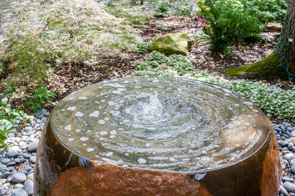 Inspiration for a large contemporary shade front yard stone formal garden in Dallas.