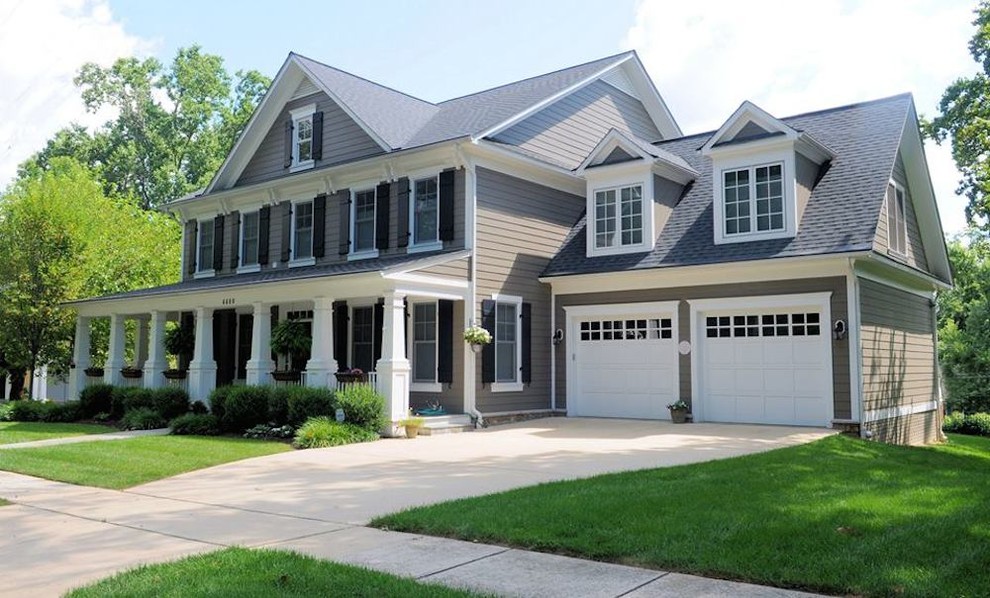 This is an example of a large arts and crafts two-storey grey exterior in DC Metro with vinyl siding and a gable roof.