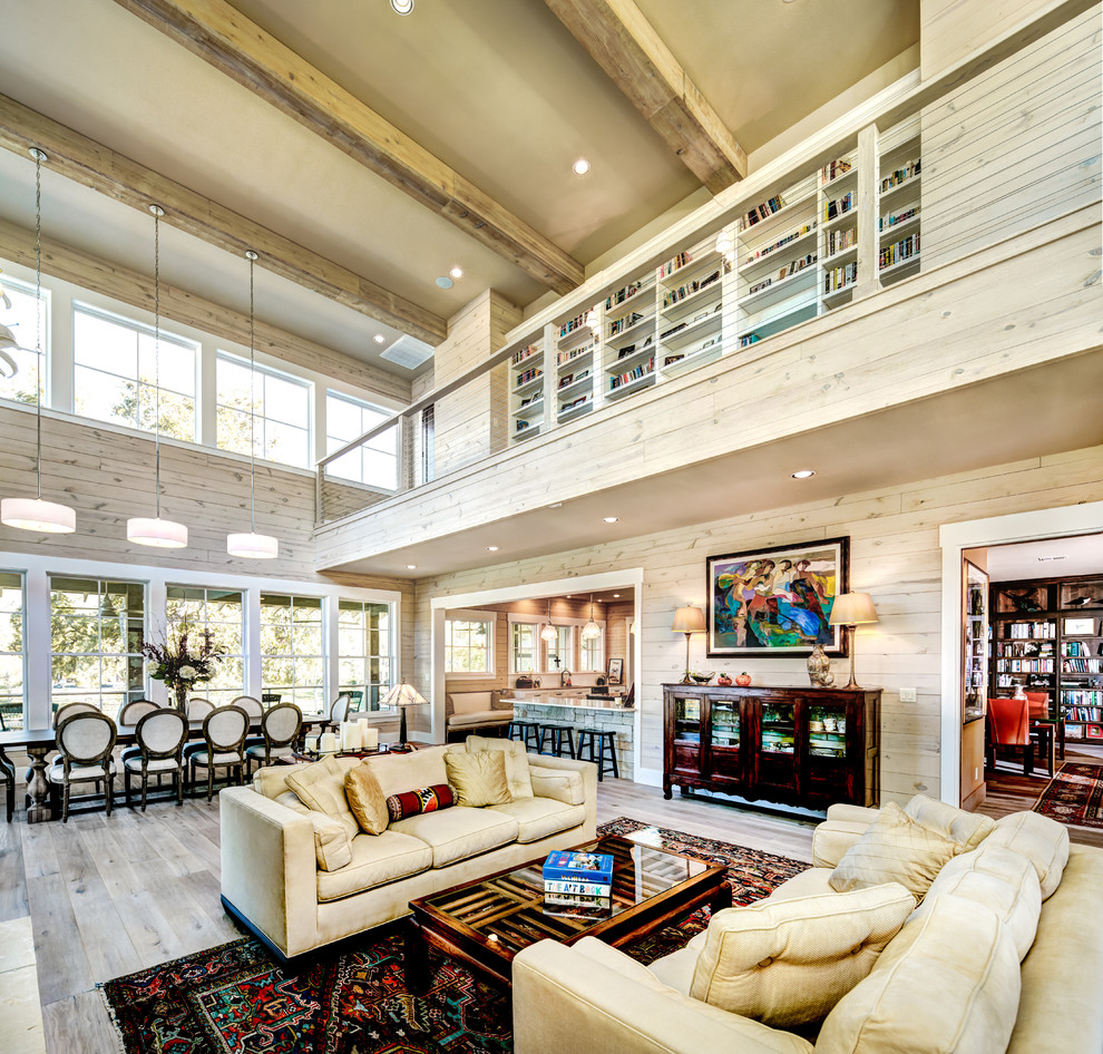 Photo of a country open concept living room in Austin with light hardwood floors.