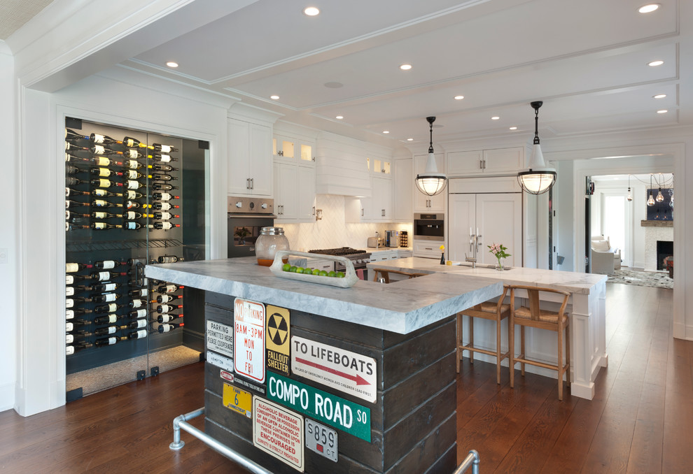 Photo of a large industrial seated home bar in New York with medium hardwood floors, an undermount sink, marble benchtops, white splashback and ceramic splashback.