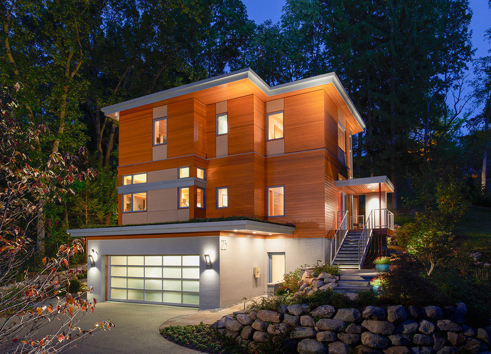 Large contemporary three-storey exterior in Detroit with mixed siding and a flat roof.