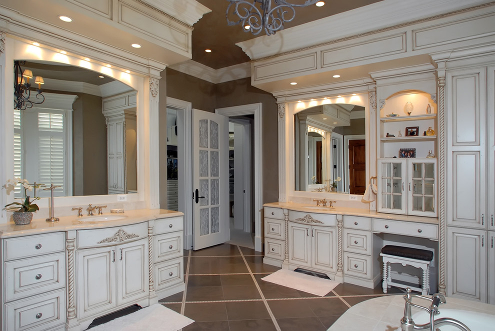 Design ideas for a traditional bathroom in Chicago with an undermount sink, raised-panel cabinets, beige cabinets and beige tile.