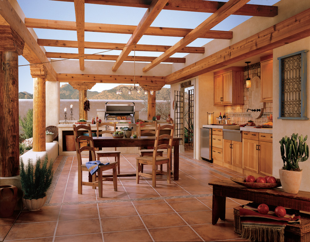 Design ideas for a mid-sized patio in Denver with an outdoor kitchen, tile and a pergola.